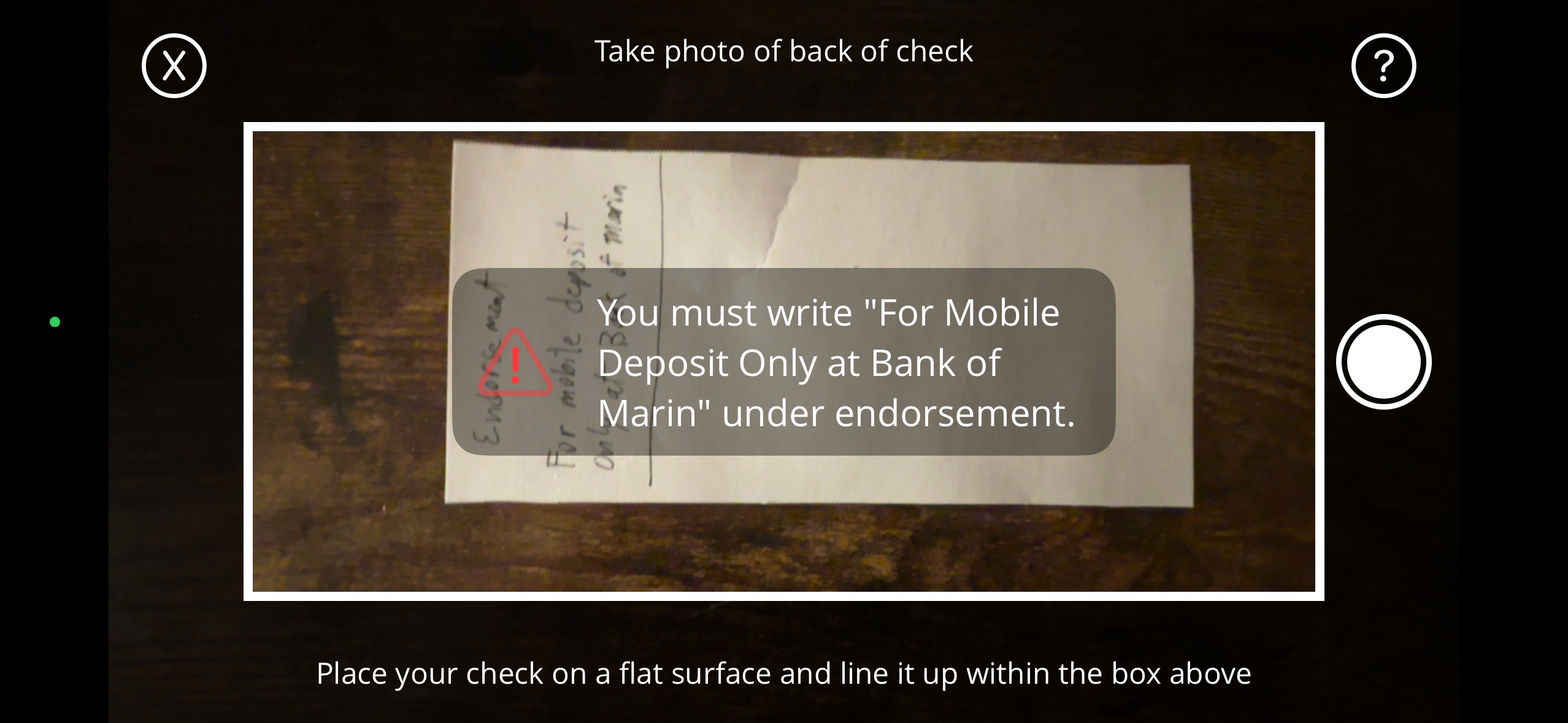 Camera screen showing the back of a check with endorsement and a reminder to write For Mobile Deposit Only at Bank of Marin under endorsement