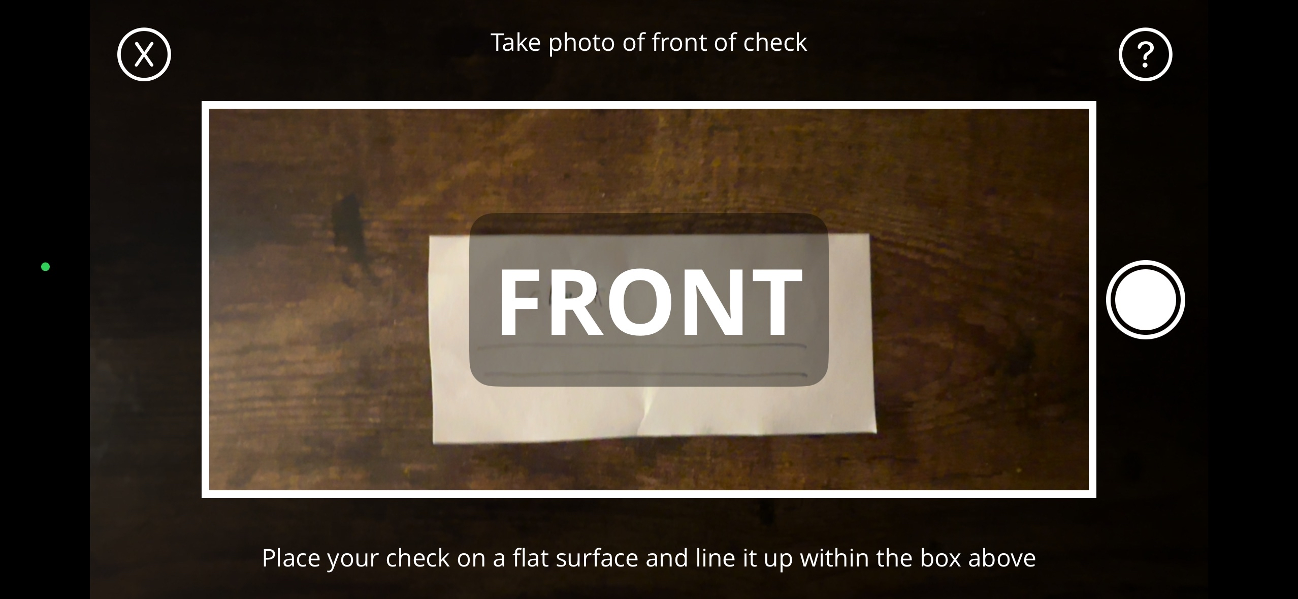 Camera screen showing check placed on a flat surface with the text Take photo of front of check